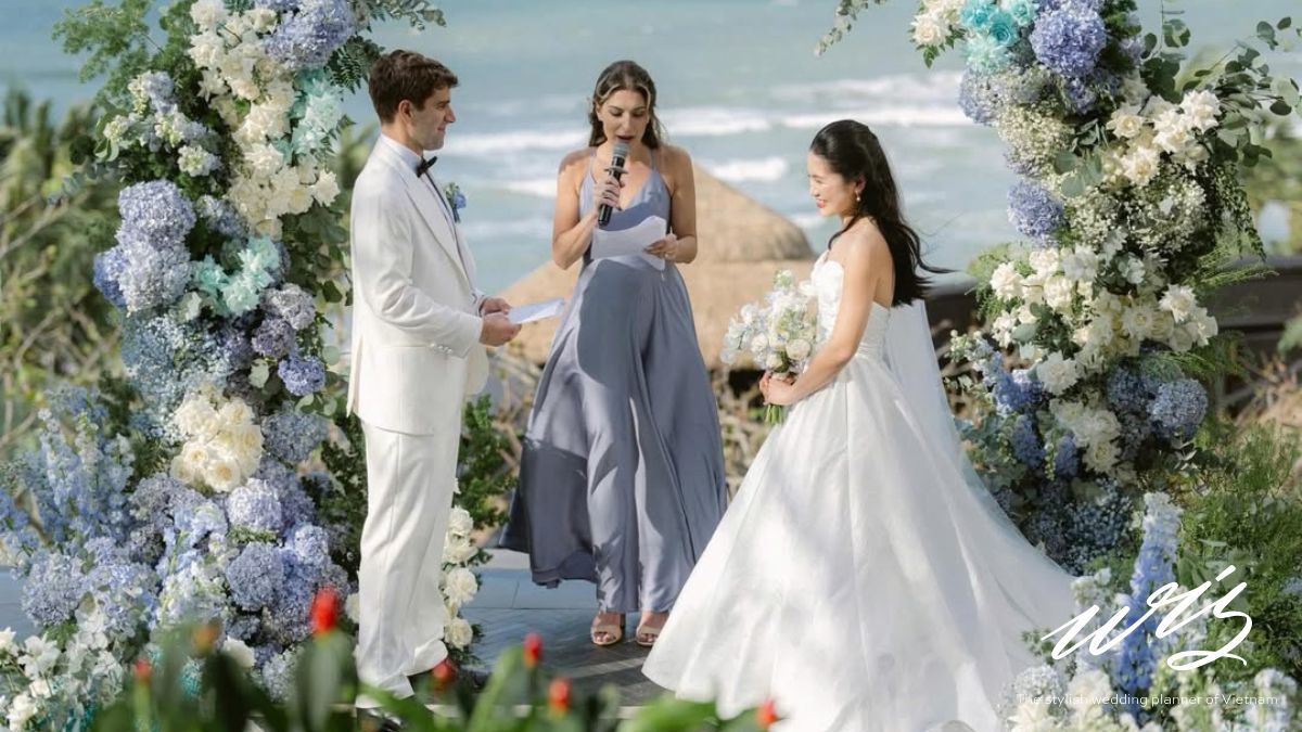 An elegant ocean-view wedding altar with blue and white hydrangeas in Da Nang, a popular luxury choice for a vietnam destination wedding cost
